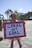 A smiling young person holding a sign supporting space sustainability.