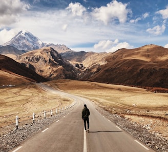 man walking on road