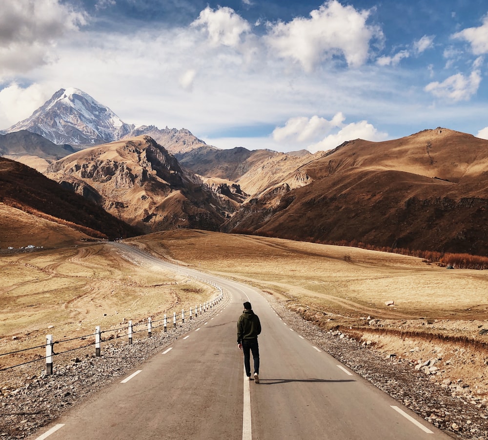 man walking on road