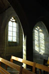 Sunlight filtering through stained glass in a historic venue hosting the association's cultural event.