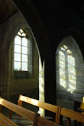 Sunlight filtering through stained glass in a peaceful chapel.