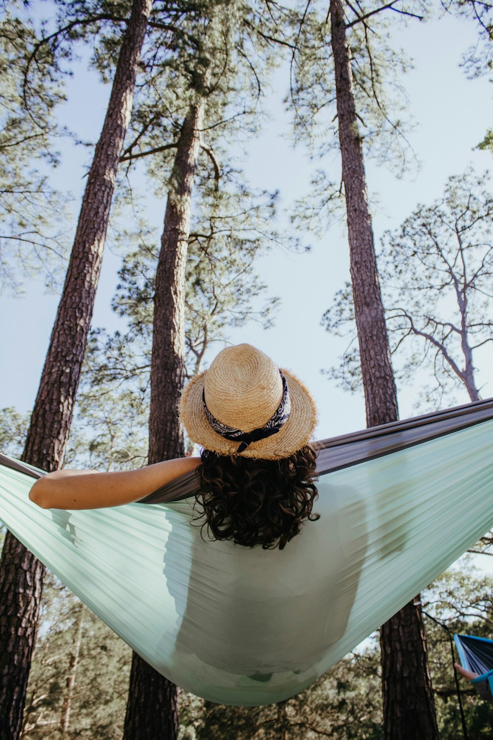 woman sitting on green hammock outdoors