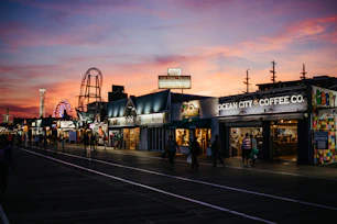 Sunset view over a bustling Myrtle Beach boardwalk with colorful shops and the iconic SkyWheel.
