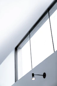 Elegant aluminum fixed window showcasing minimalist frame and bright interior light.