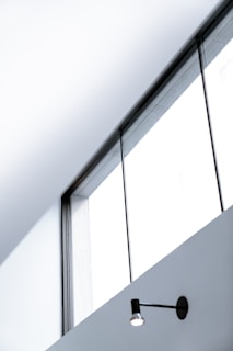 turned-on black sconce lamp