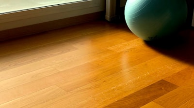 green fitness ball on parquet floor