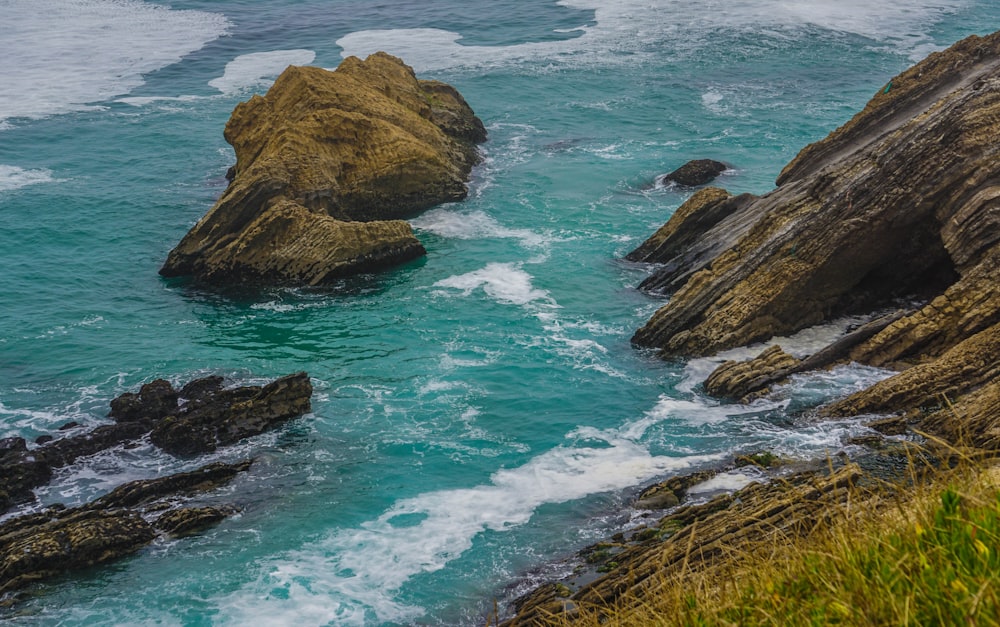 aerial photography of rock formations on body of water during daytime