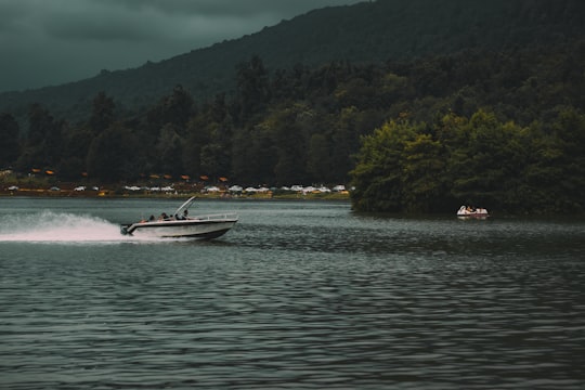 white motorboat on calm body of water during daytime in Mazandaran Province Iran