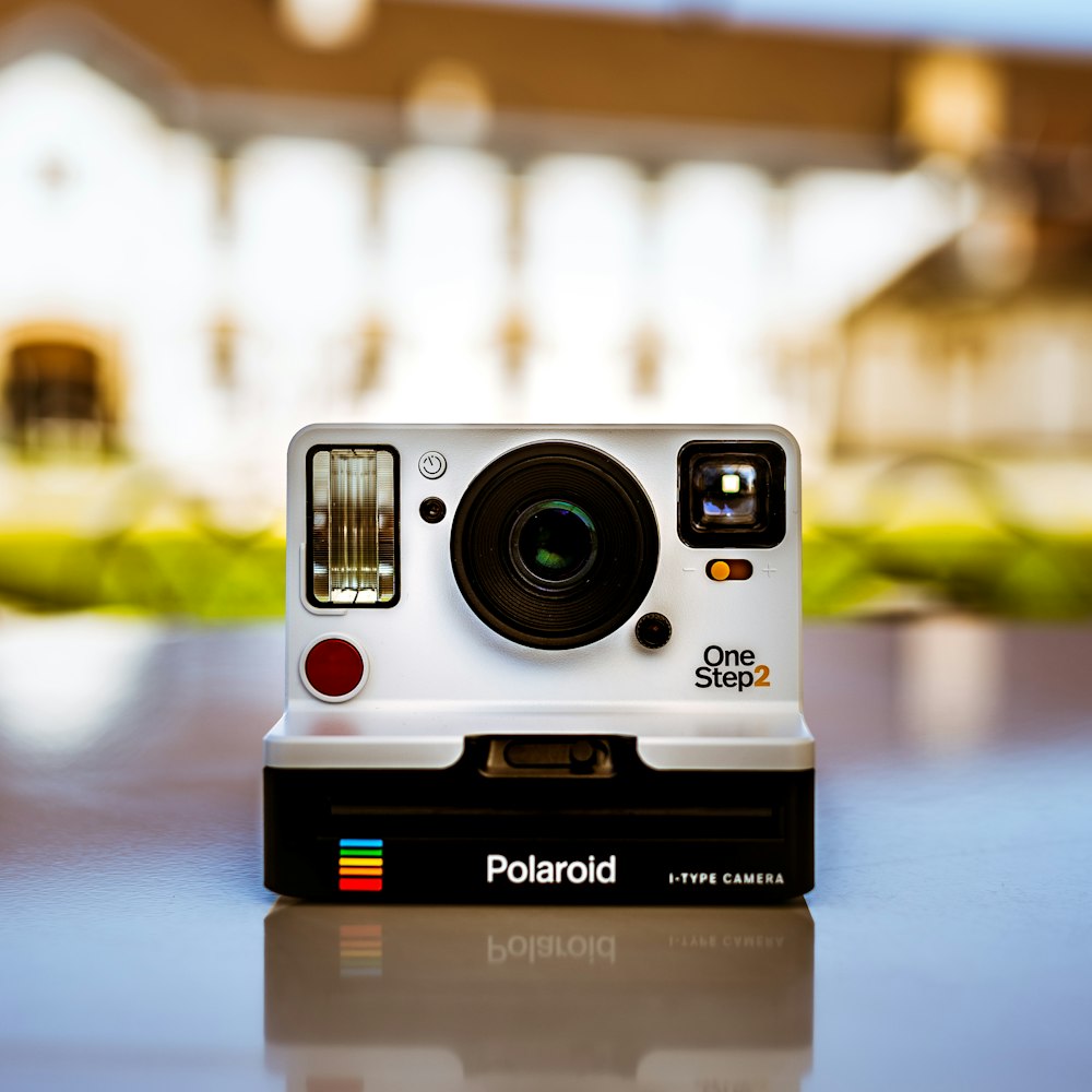 shallow focus photo of white Polaroid instant camera