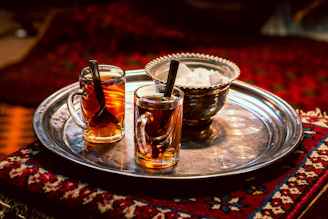 full clear glass teacups on gray tray
