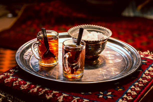 full clear glass teacups on gray tray