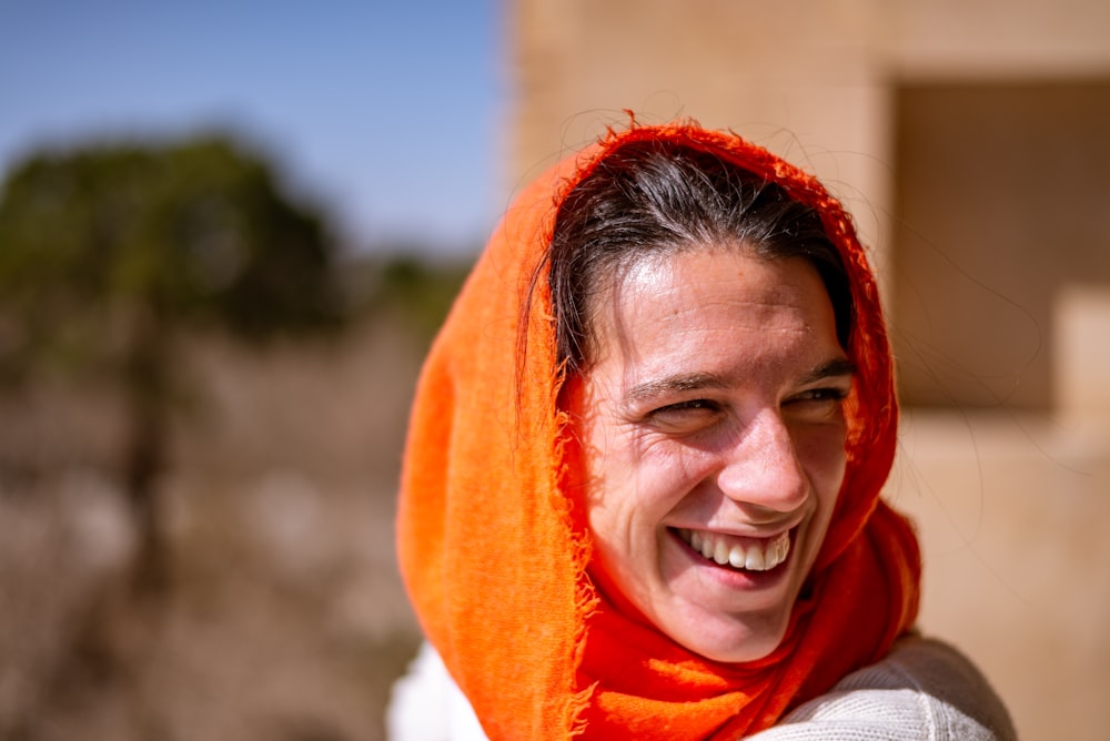 Lächelnde Frauen tragen orangefarbenen Schal