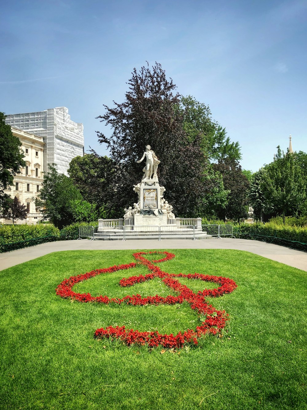 white statue beside green tree