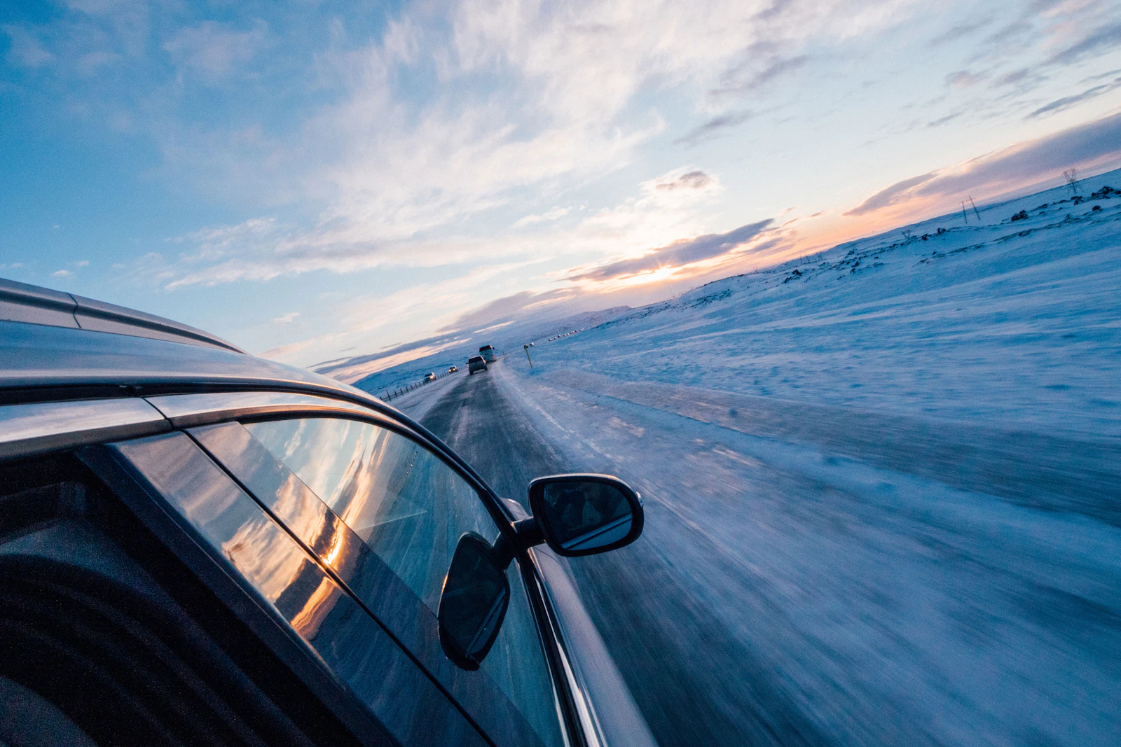A car driving on a snow-lined road in Iceland