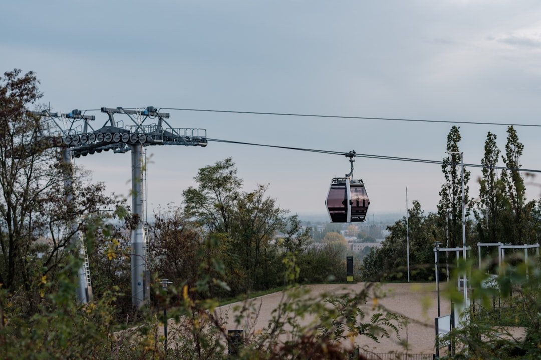 black and brown cable car under blue and white sky during daytime