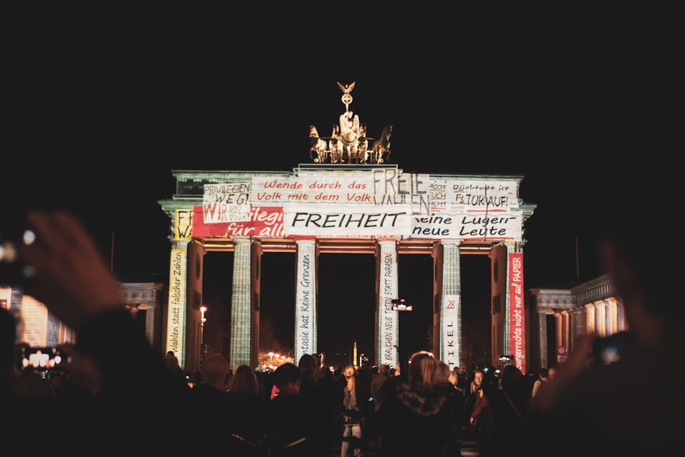 crowd of people in front of an archway