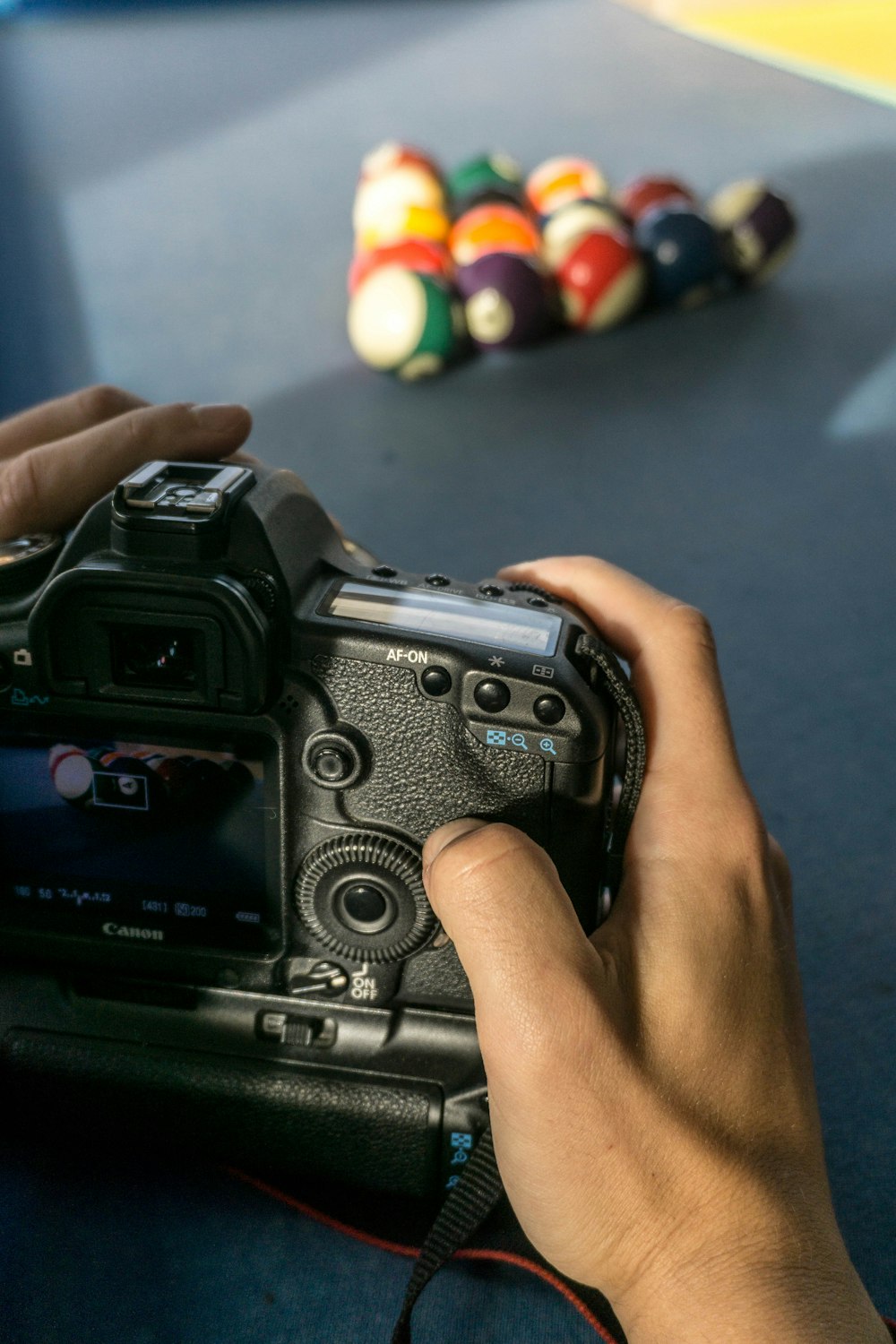 person taking photo on billiard balls