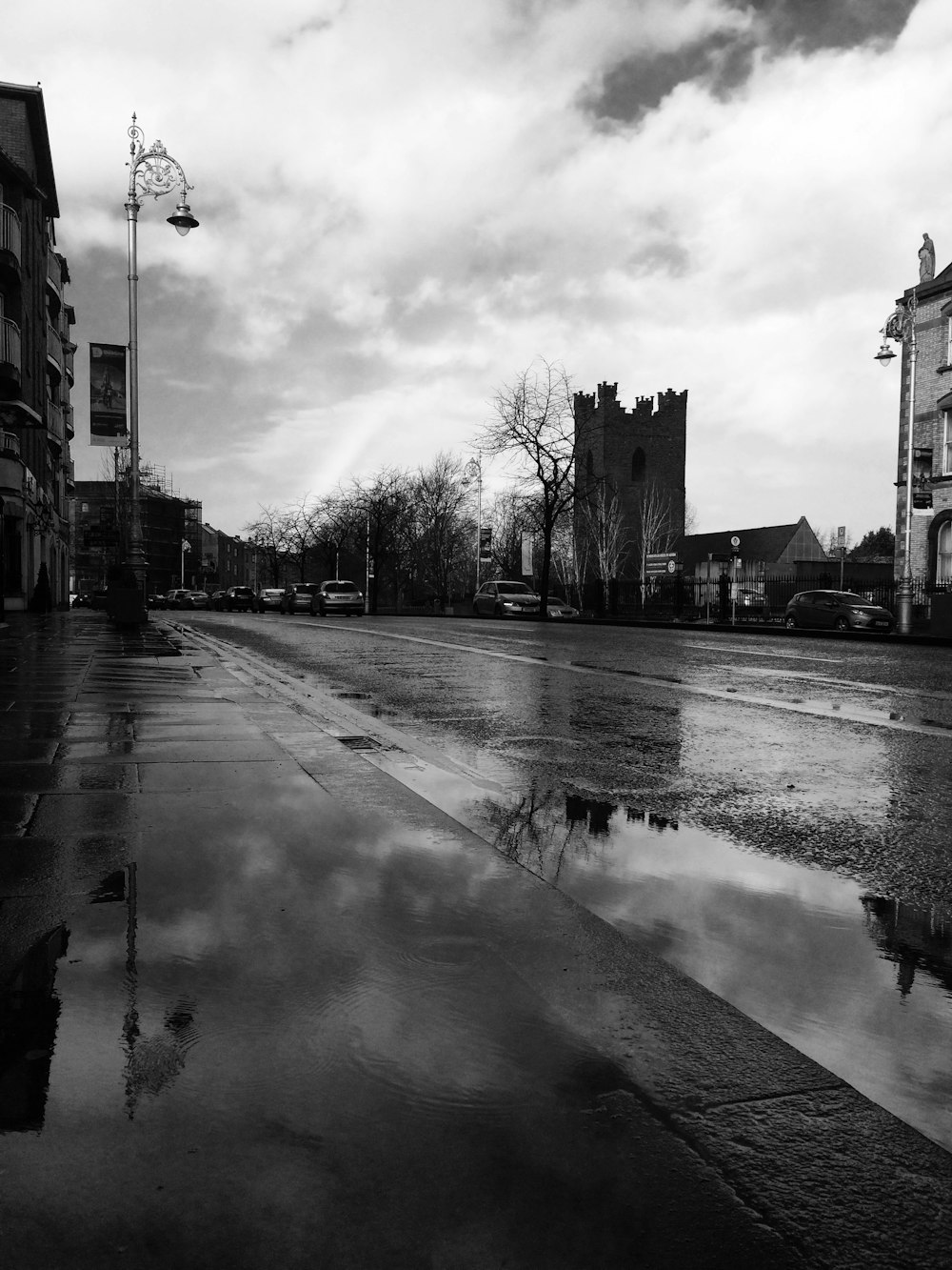 buildings, road, and vehicles during day