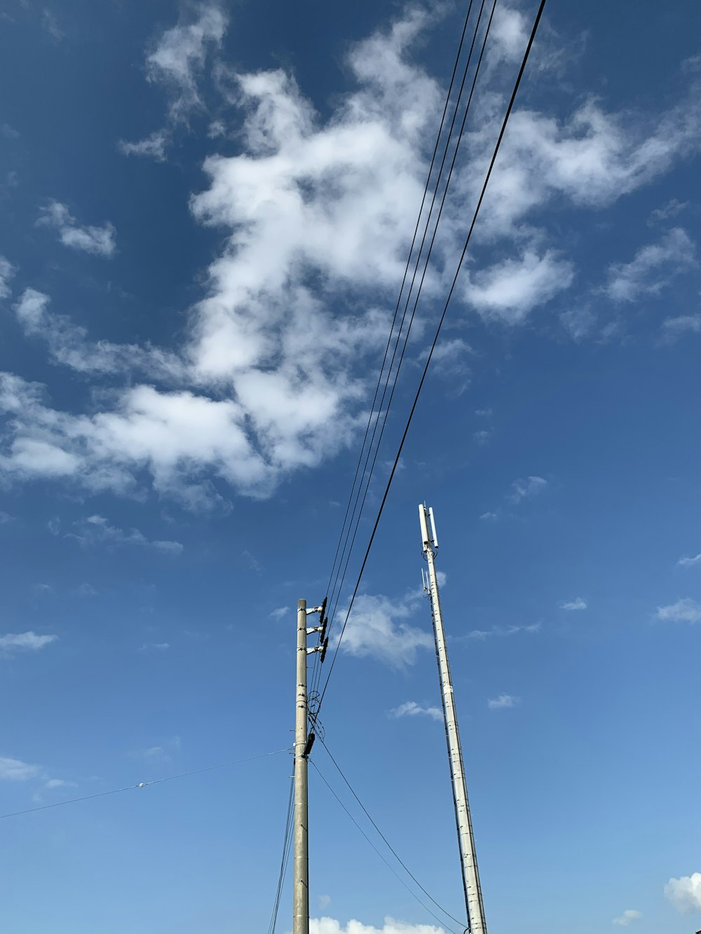 grey telephone post during cloudy day