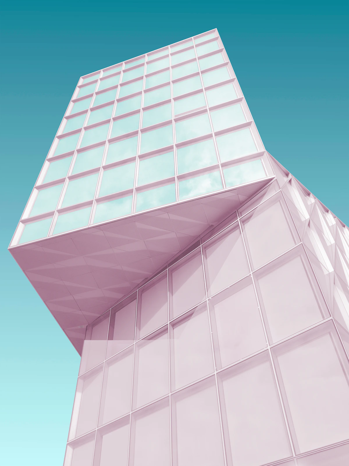 A pink building corner against a blue sky