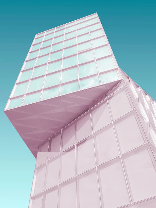 A pink building corner against a blue sky