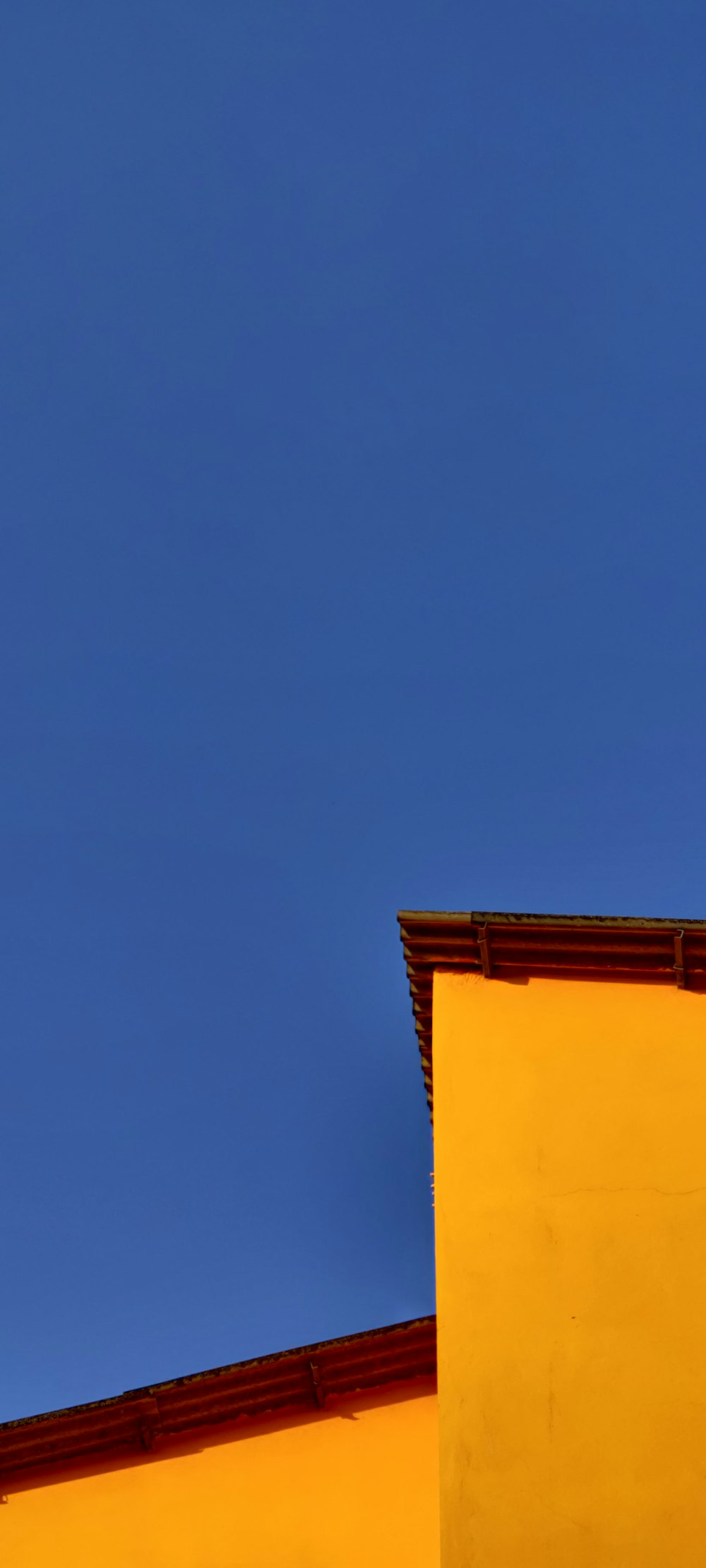 a clock on the side of a yellow building