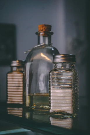 Set of three Opex oil bottles with different viscosities on a metallic surface