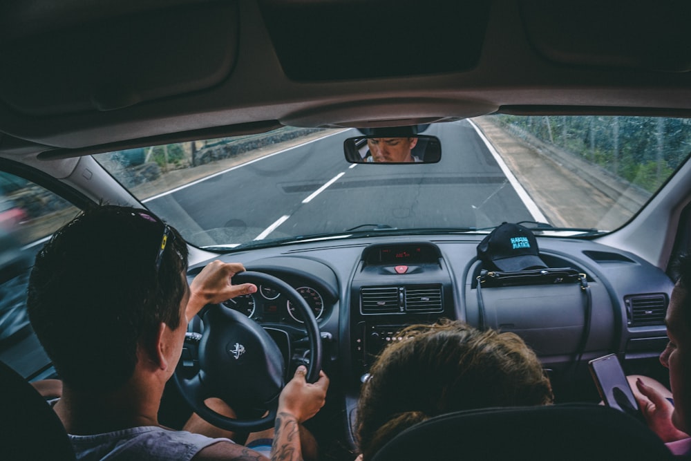 man driving inside vehicle