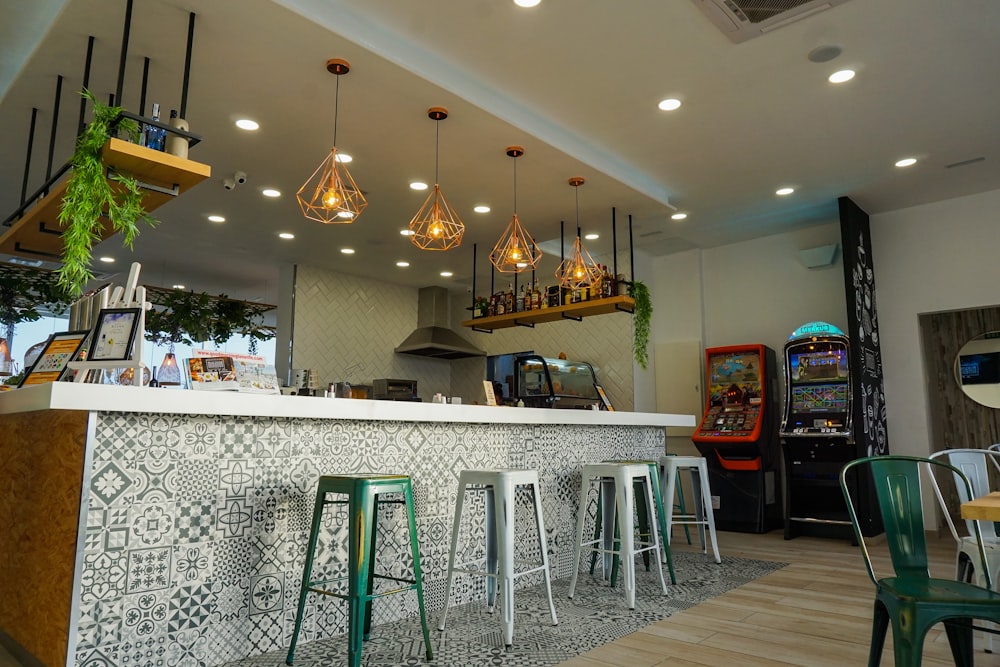 three white and two green metal bar stools