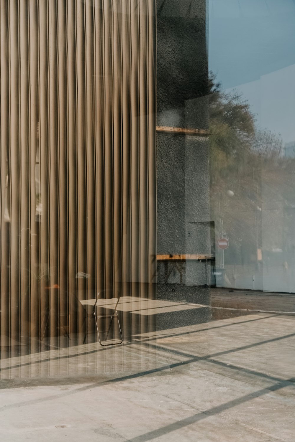 a bench sitting in front of a tall building