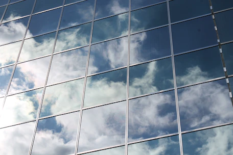 Close-up of sparkling clean commercial building windows reflecting the blue sky.