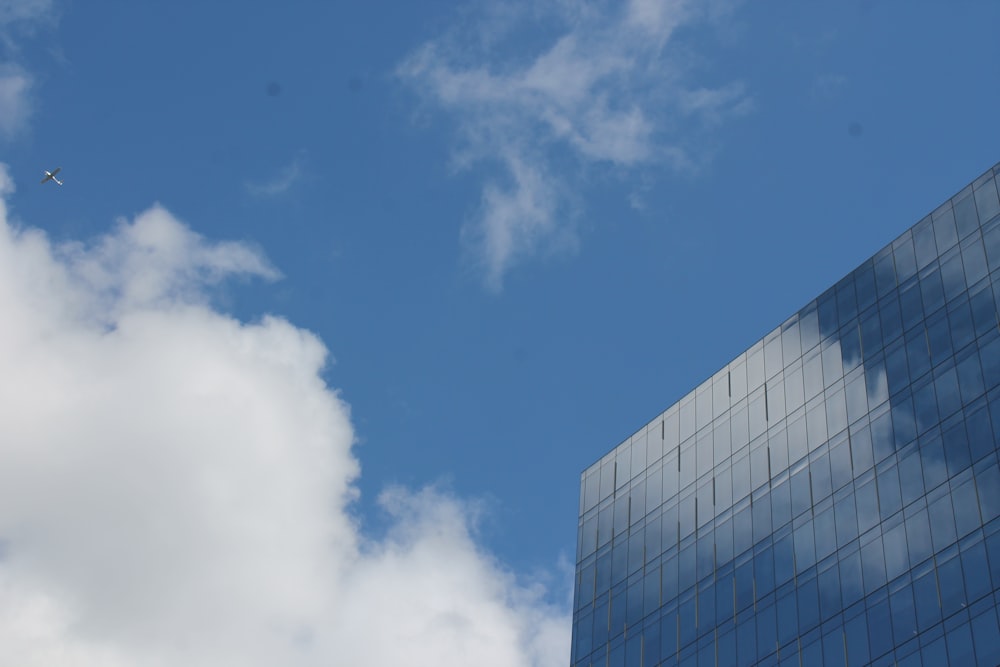 glass building under white and blue sky