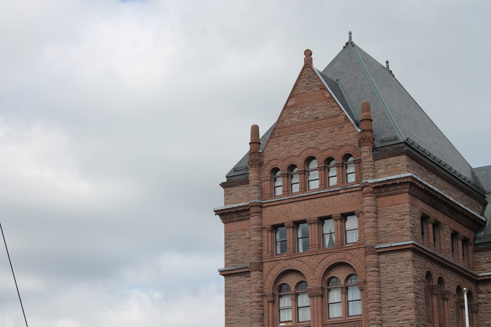 brown brick house under gray sky