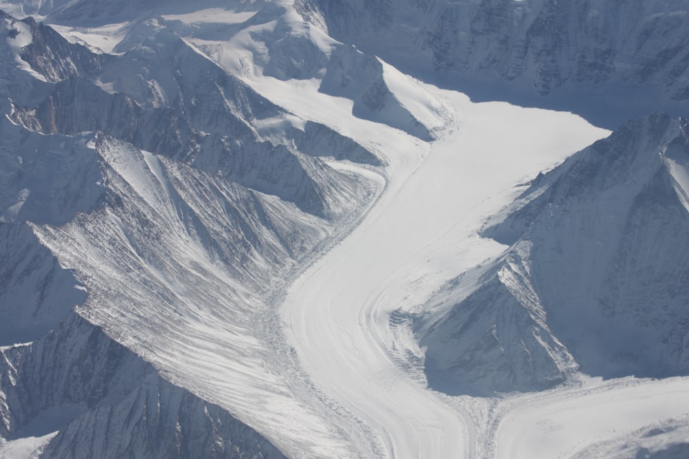 an aerial view of a snow covered mountain range