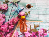 Rustic wooden table with assorted honey jars and blooming flowers