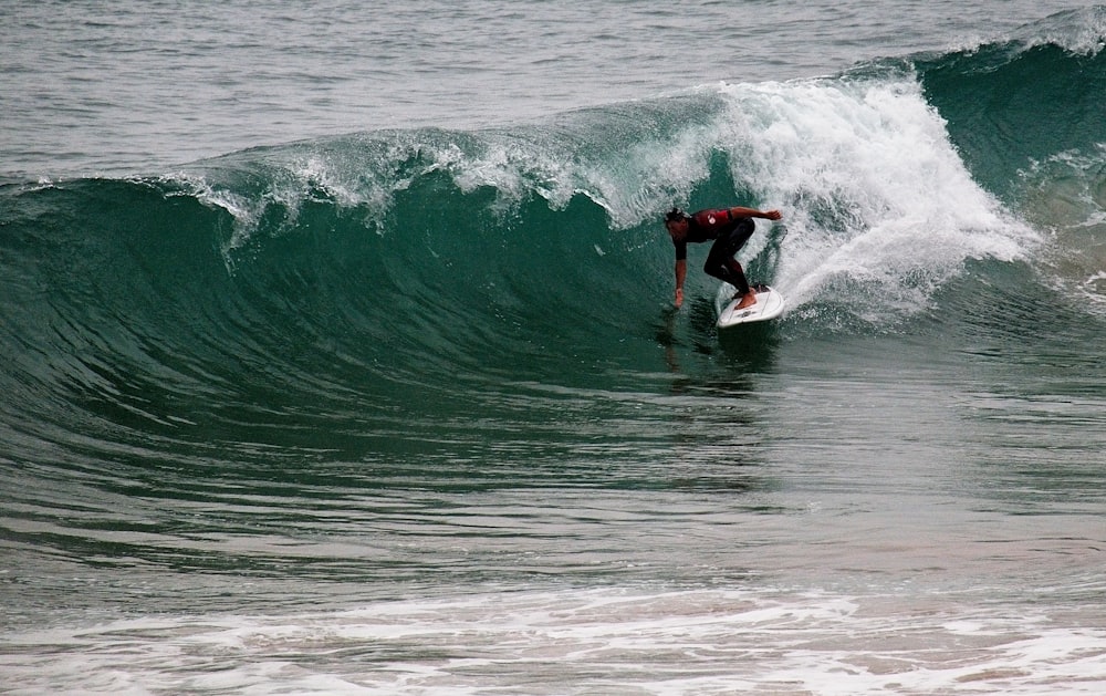 surfing man touching water