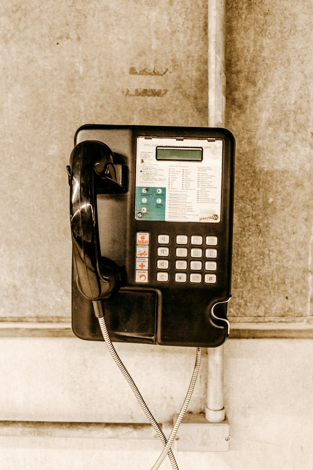 white and black coin operated telephone