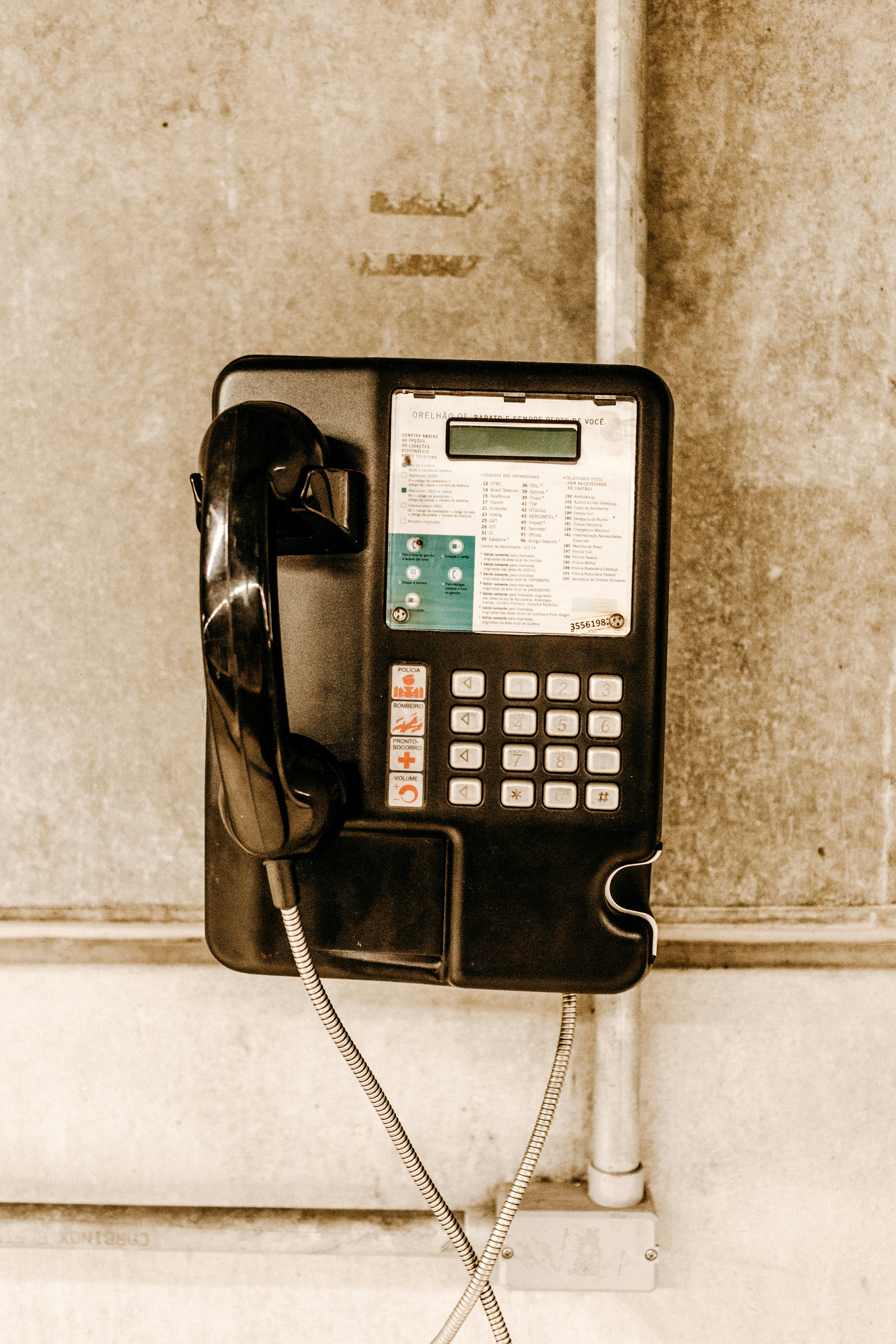 white and black coin operated telephone