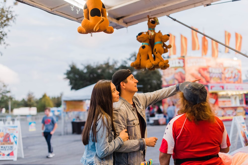 Scooby-Doo plush toys hanging over man and woman