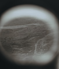 Rounded vintage TV screen displaying a lively travel vlog with mountains