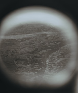 Rounded screen showing a travel vlog with scenic mountain views.