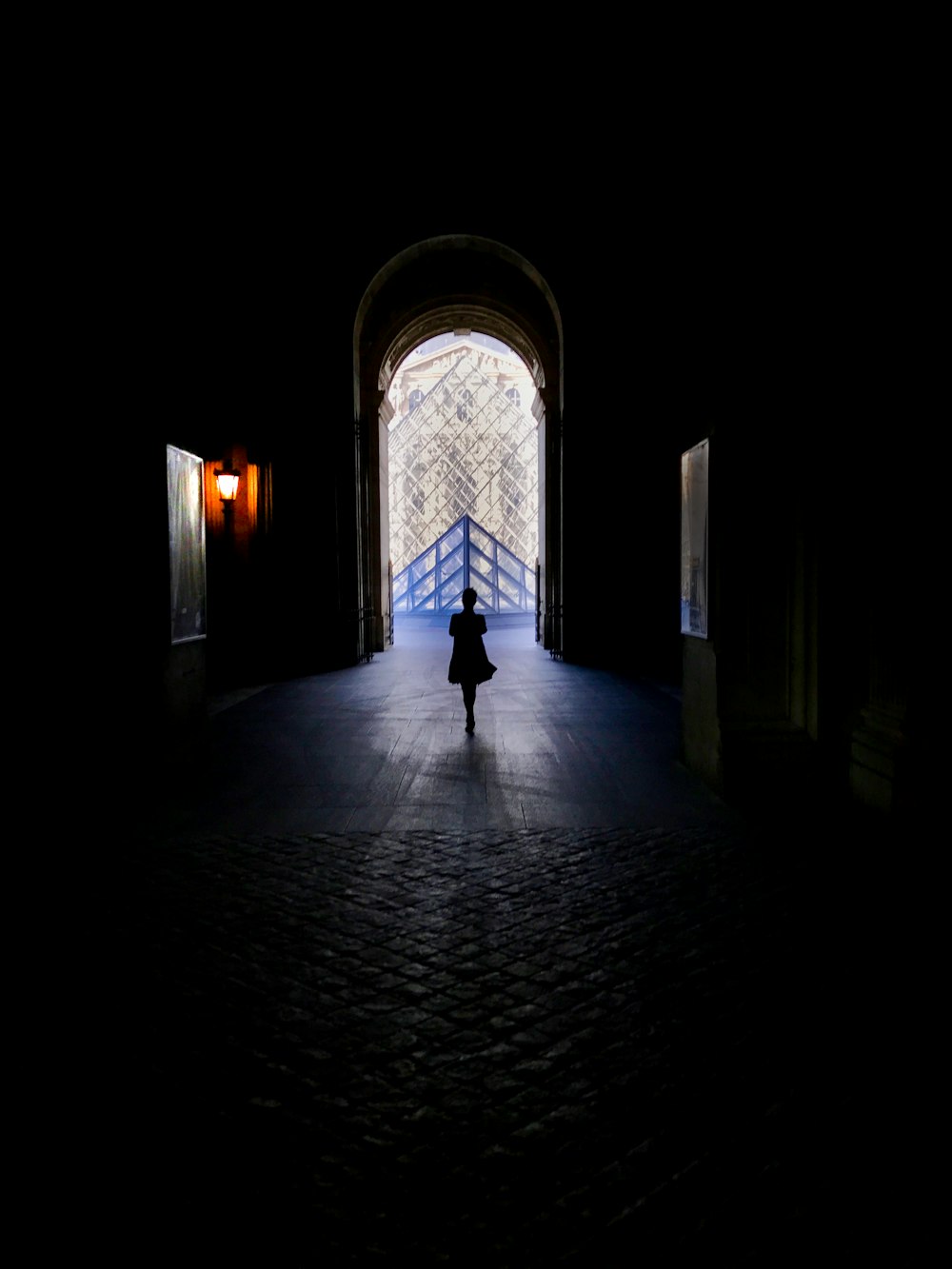 silhouette of person walking inside building
