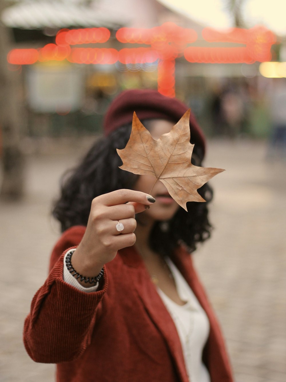 woman standing and holding leaf
