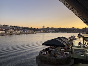 View of Barranquilla’s Malecon del Rio at sunset with locals and tourists enjoying the riverside.