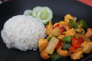 Colorful stir-fried vegetables and tender chicken glazed in a glossy ginger-soy sauce served over jasmine rice