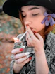woman lighting cigarette stick