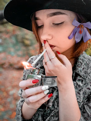 woman lighting cigarette stick