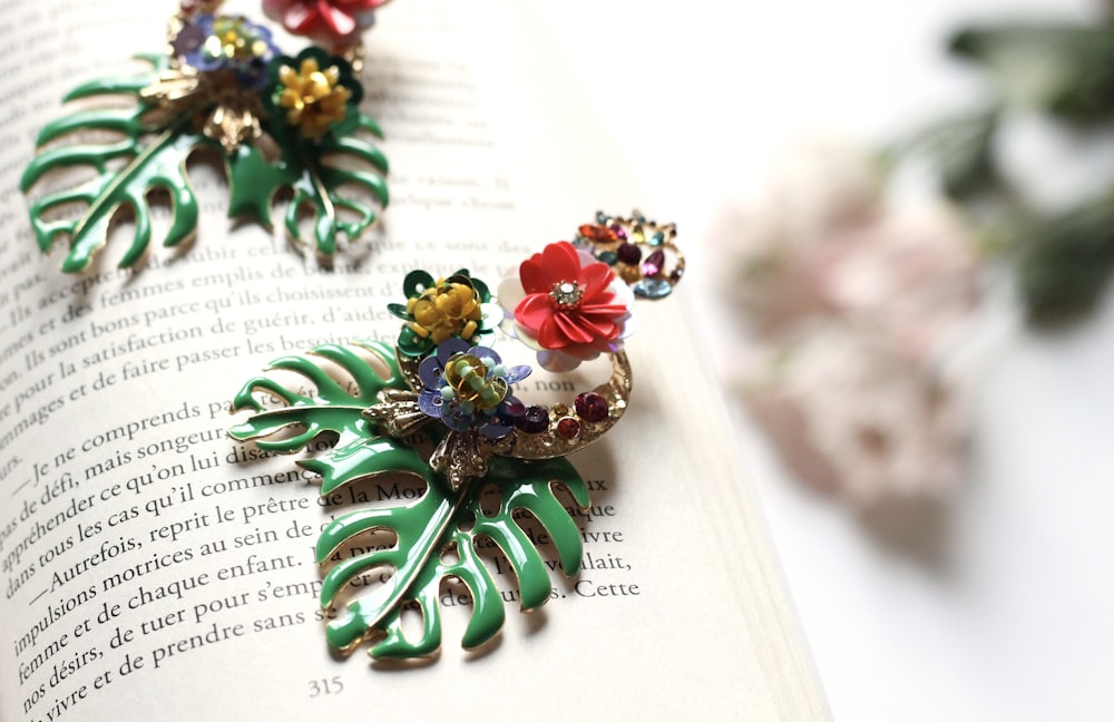 two multicolored floral brooch