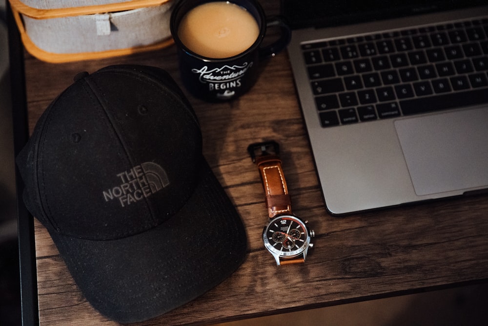 cap and watch on desk