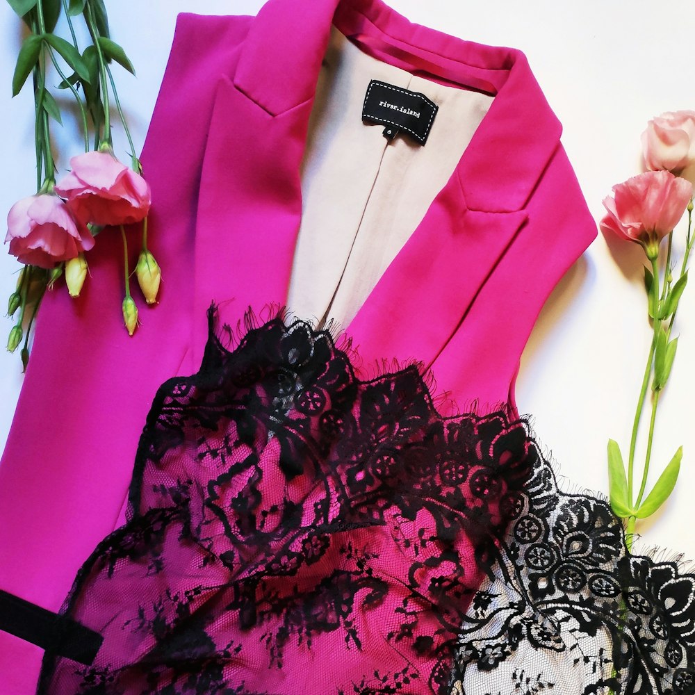 pink peaked lapel sleeveless blazer and pink flower